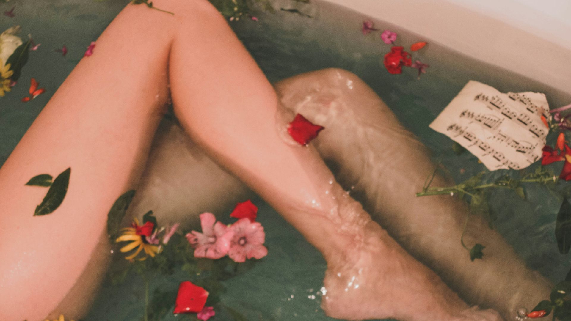 bathtub with water and flowers