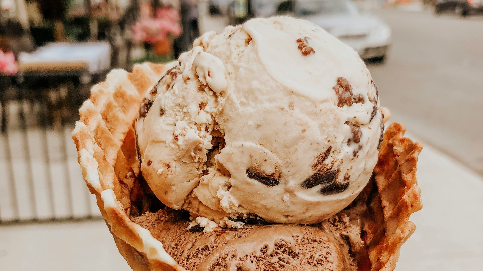 person holding ice cream in cone