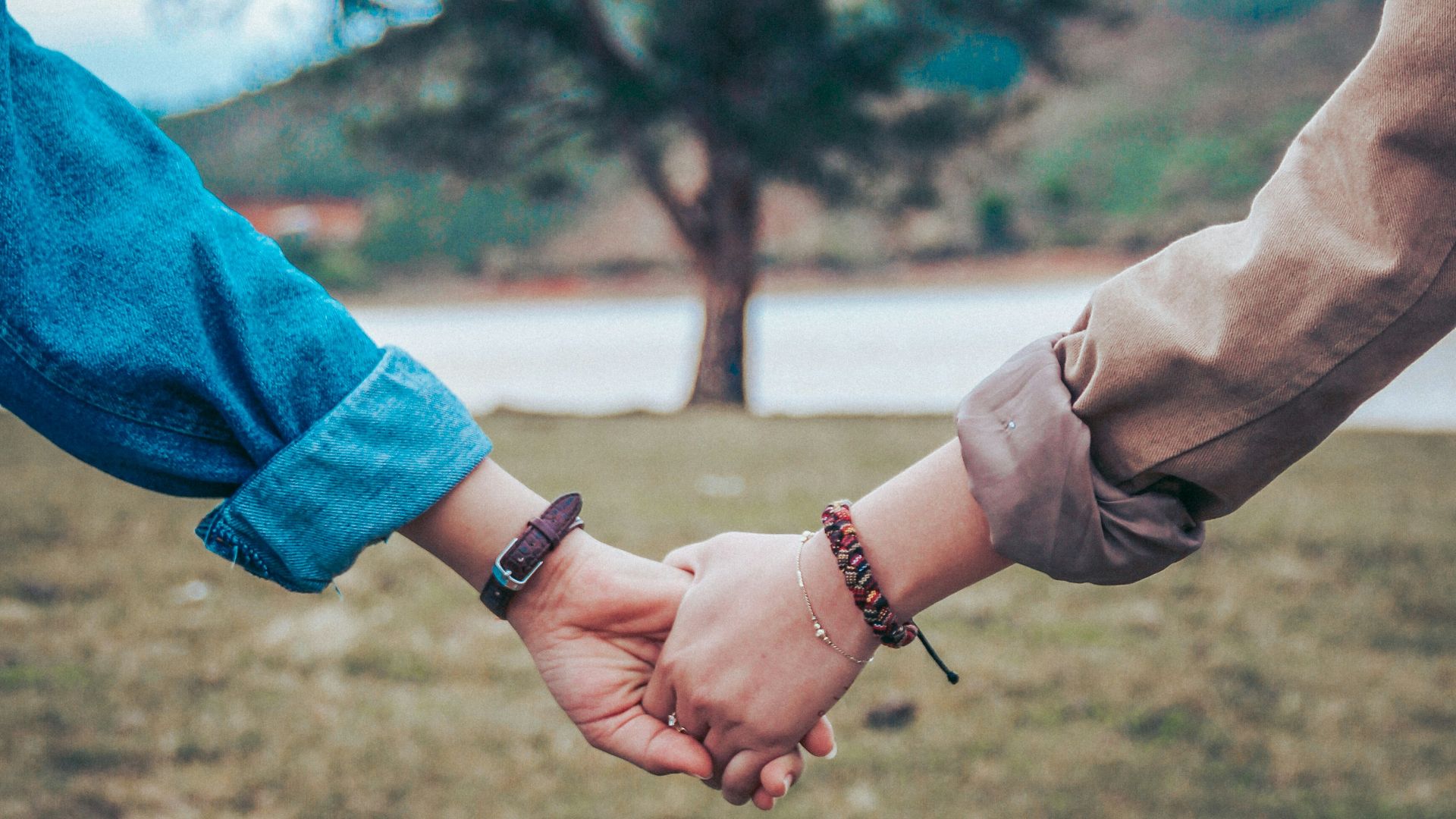 two persons holding hands