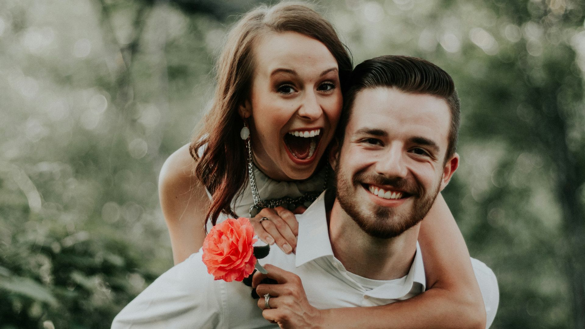 woman riding on back of man