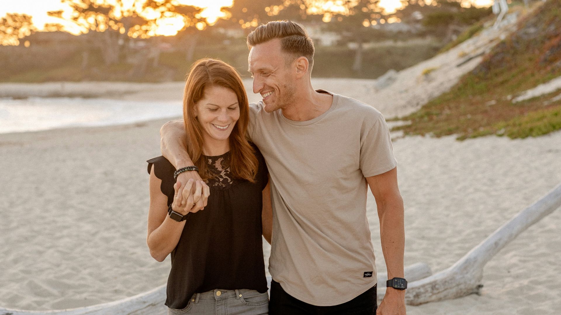 man and woman standing on beach during daytime