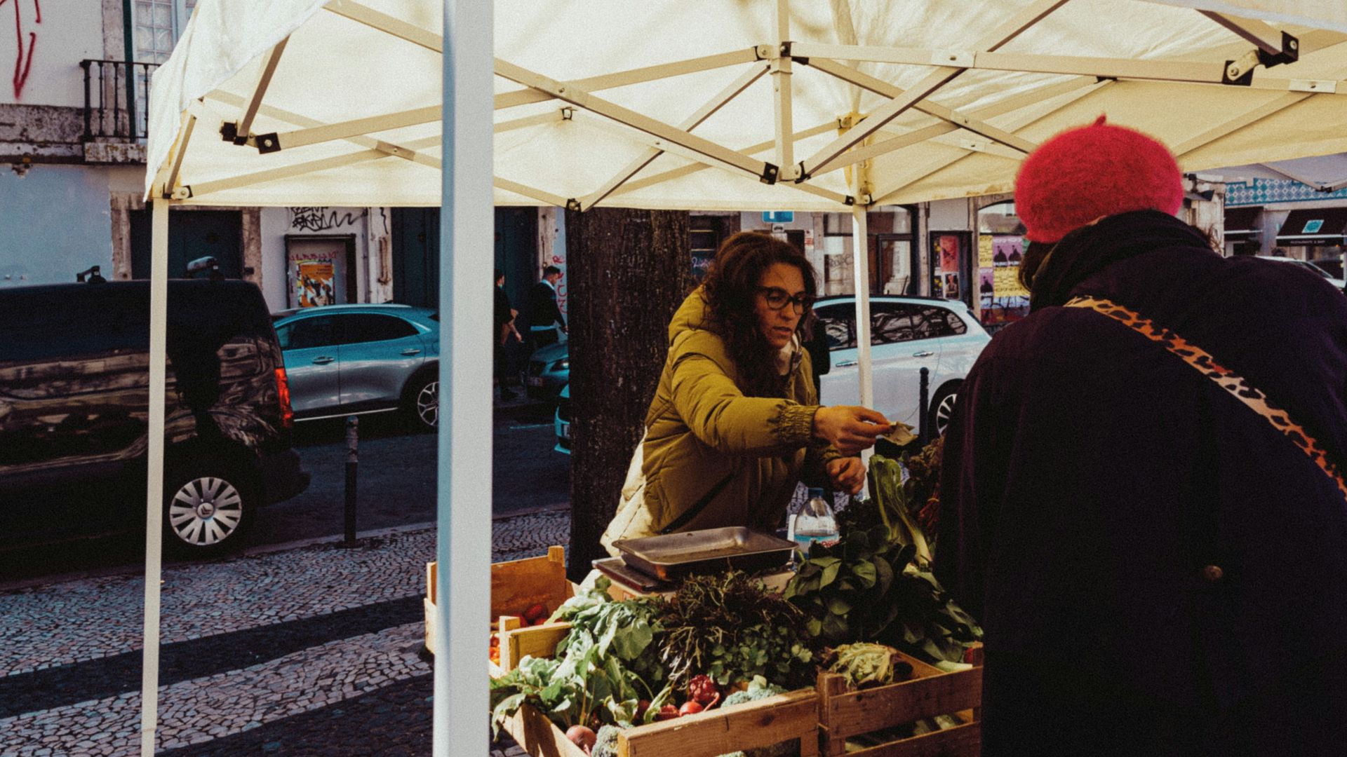 a couple of people standing under a white tent