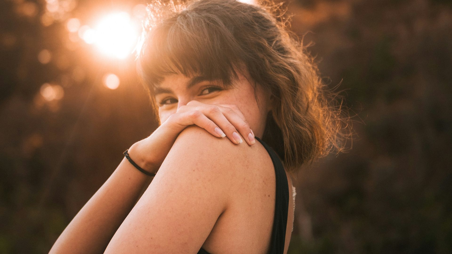 a woman in a black top is posing for a picture