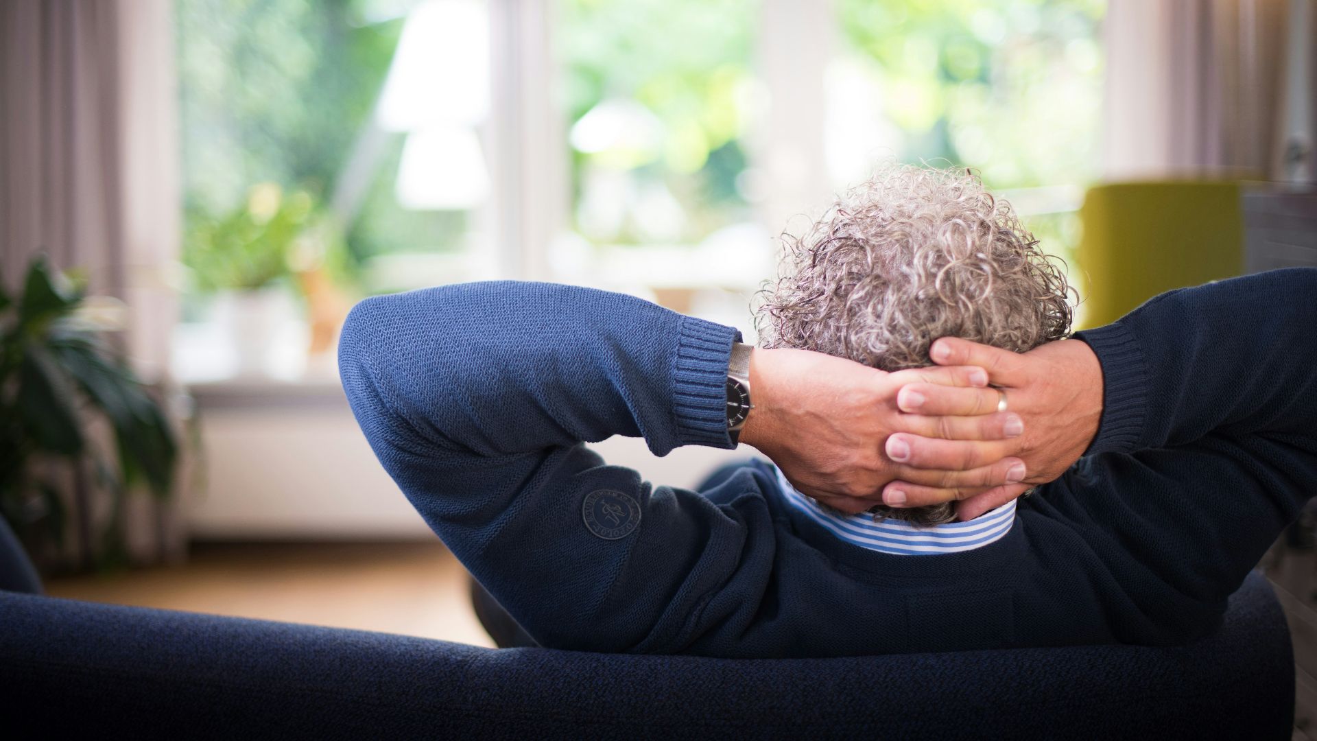 man lying on black couch
