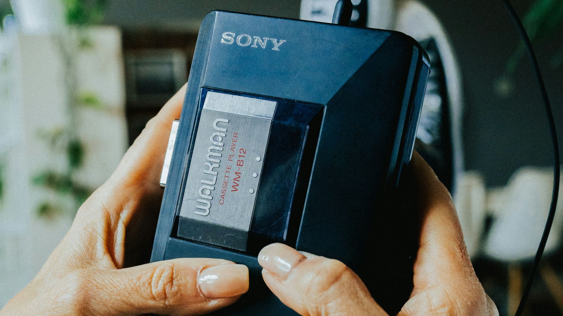 a woman holding a video game console in her hands