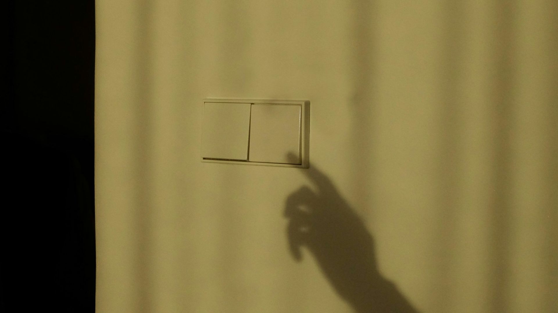 a shadow of a person holding a piece of paper