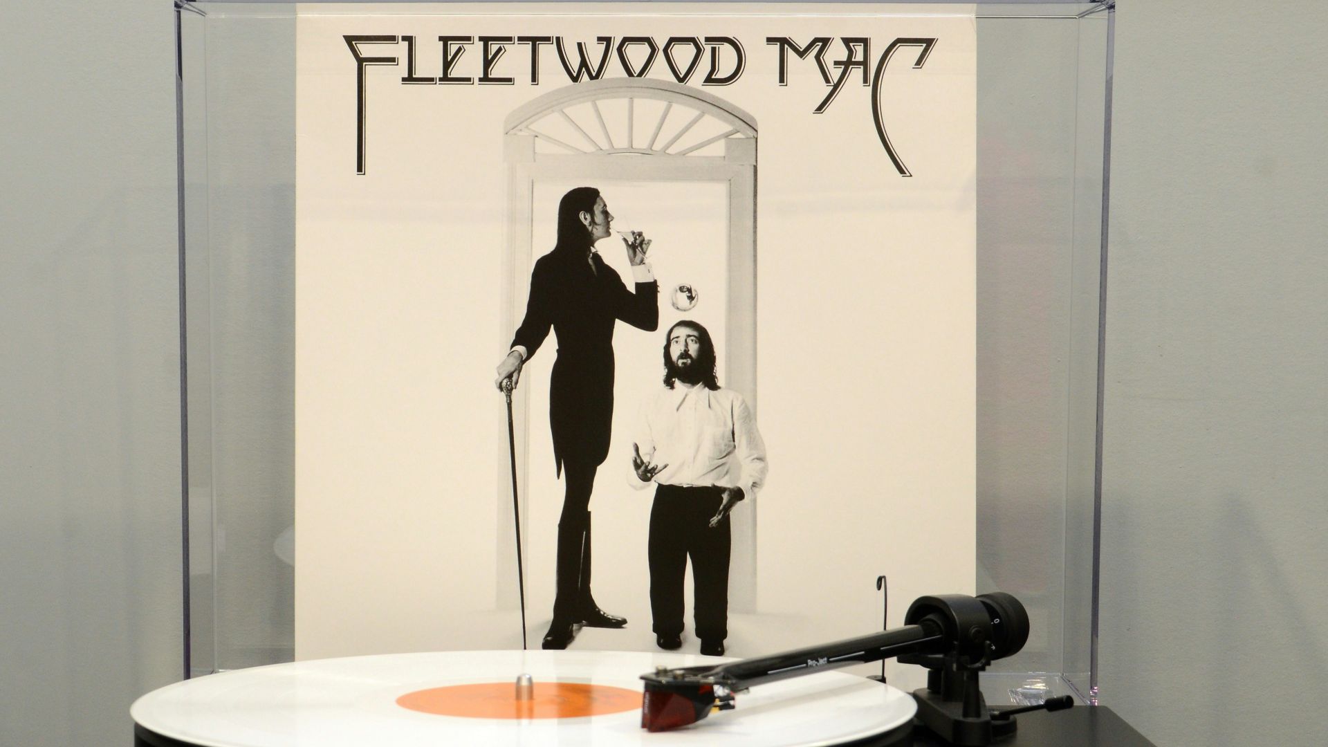 a man and a woman standing in front of a mirror