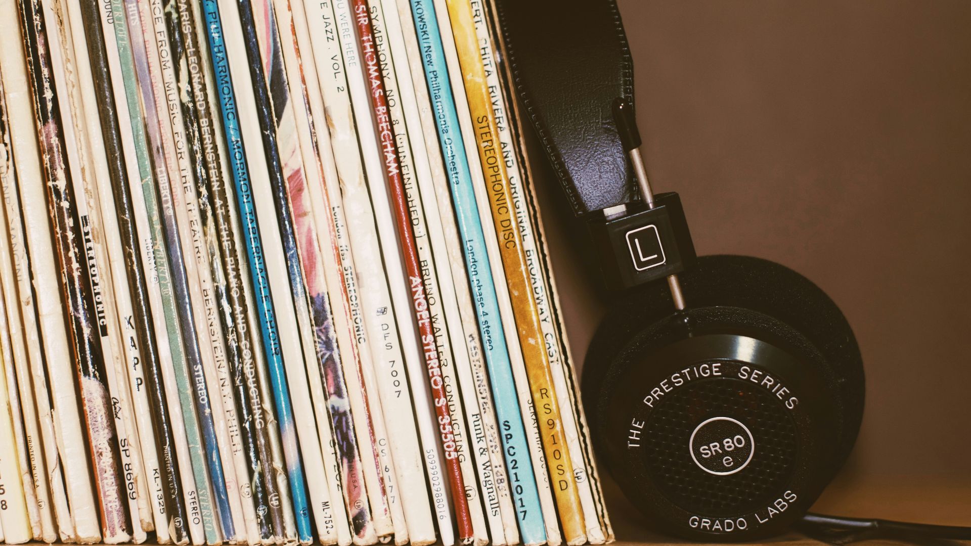 wireless headphones leaning on books