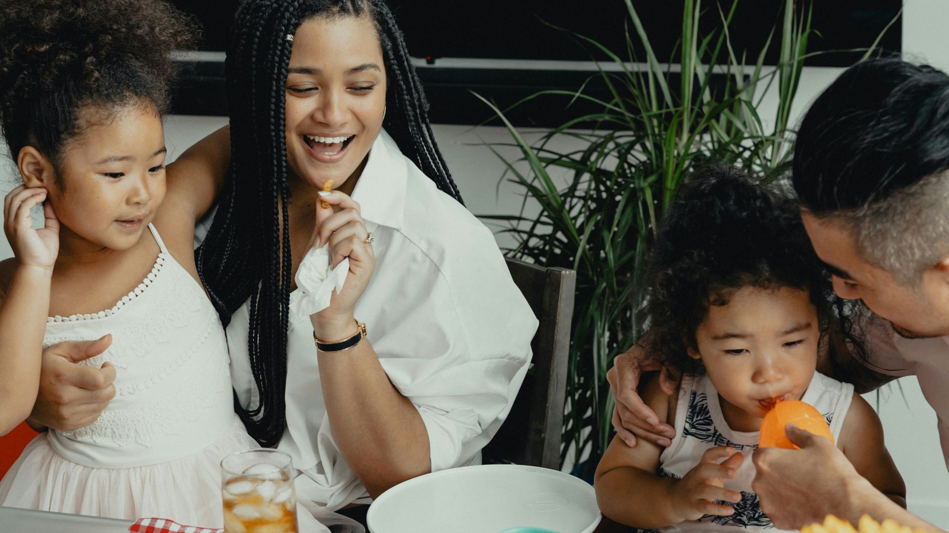 woman in white sleeveless dress sitting beside woman in white sleeveless dress