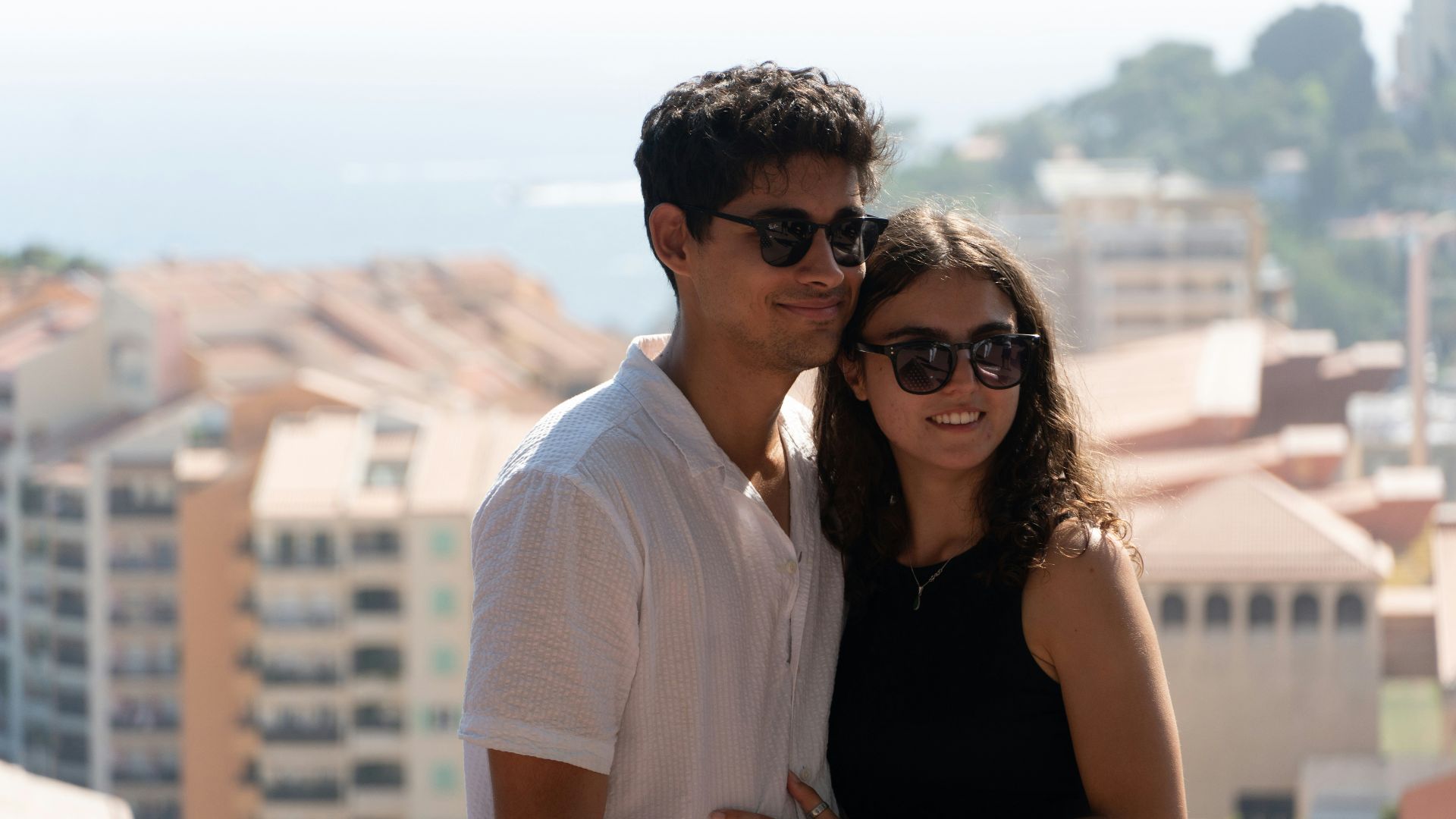 Young couple posing with buildings in background