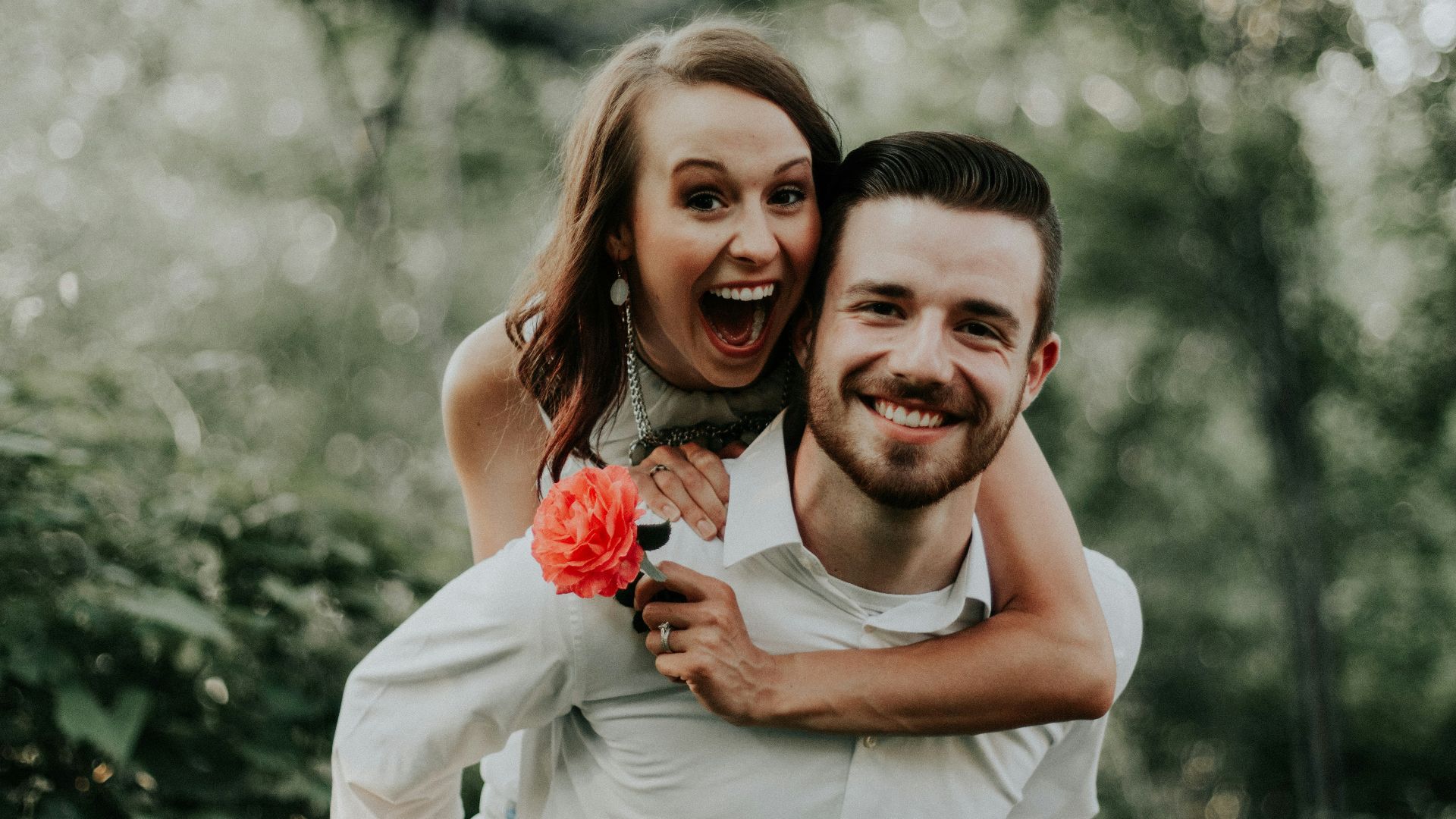 woman riding on back of man