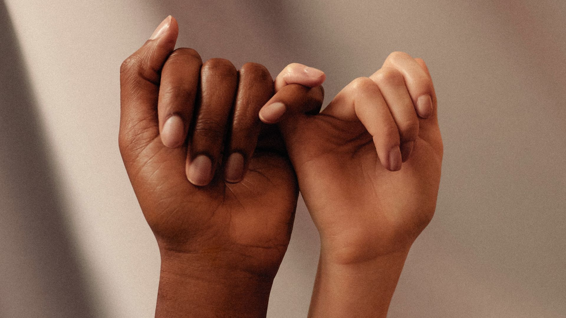 persons hand with white manicure