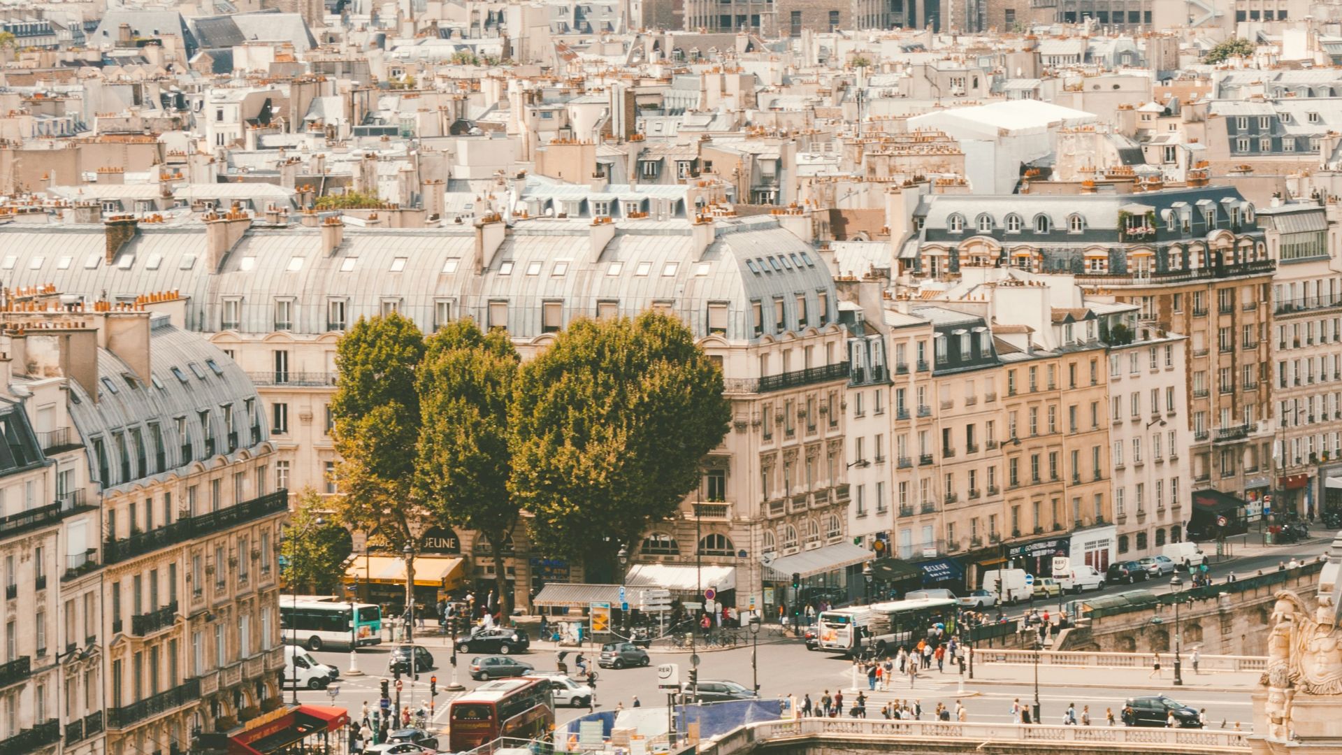 group of people walking near body of water and building under blue sky at daytime
