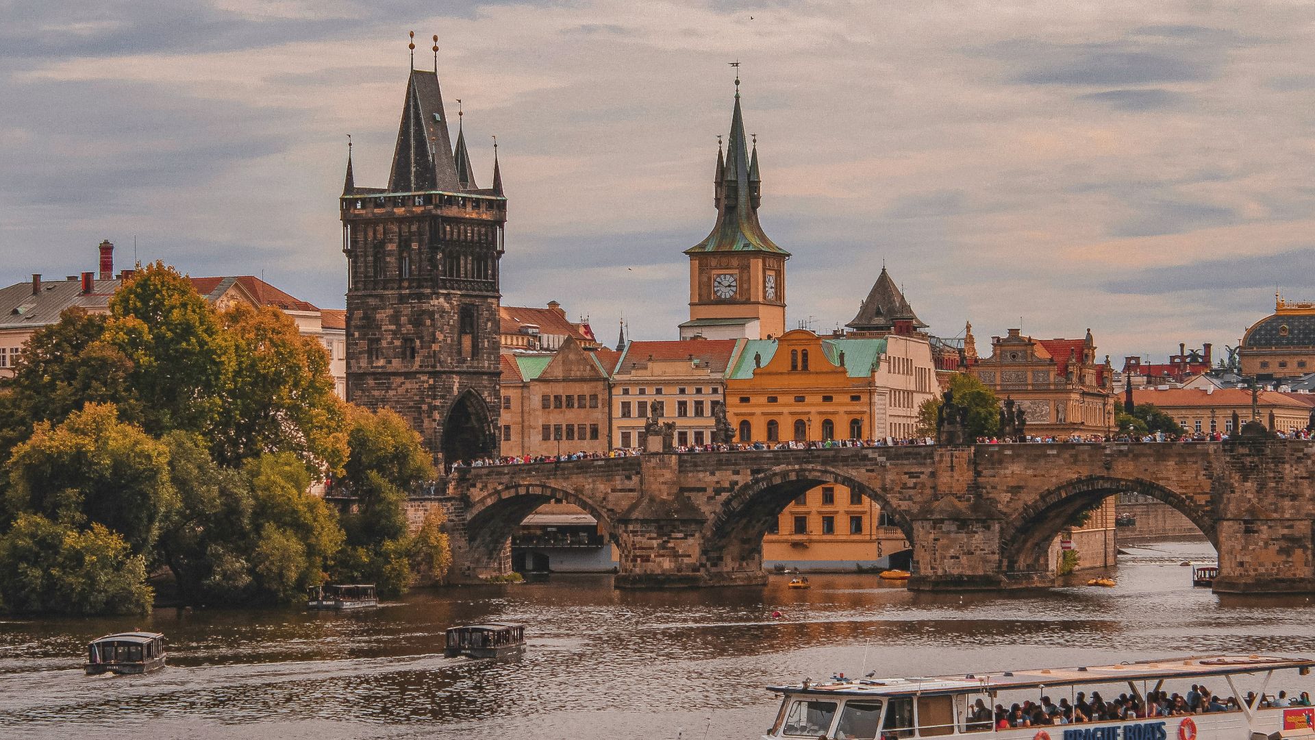 white and brown boat on river near brown concrete building during daytime