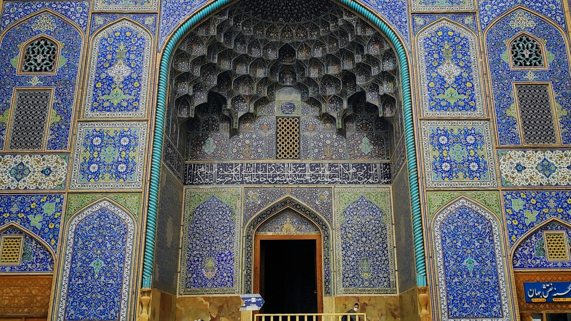 a blue and white building with a clock on it's side