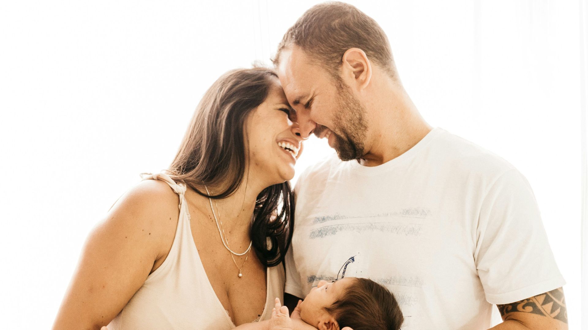 man in white crew neck t-shirt kissing woman in white dress