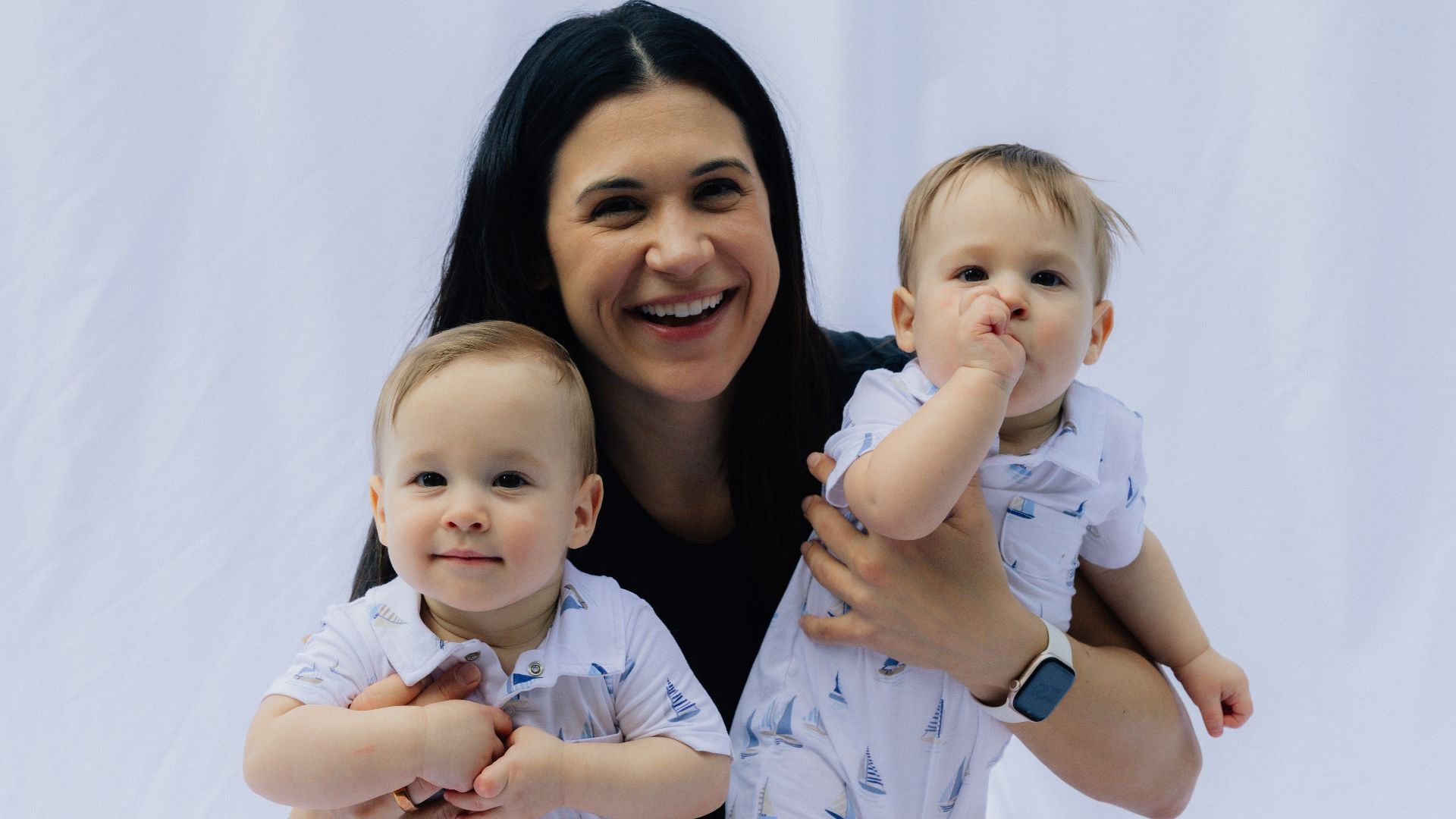 Mother holding her two young children
