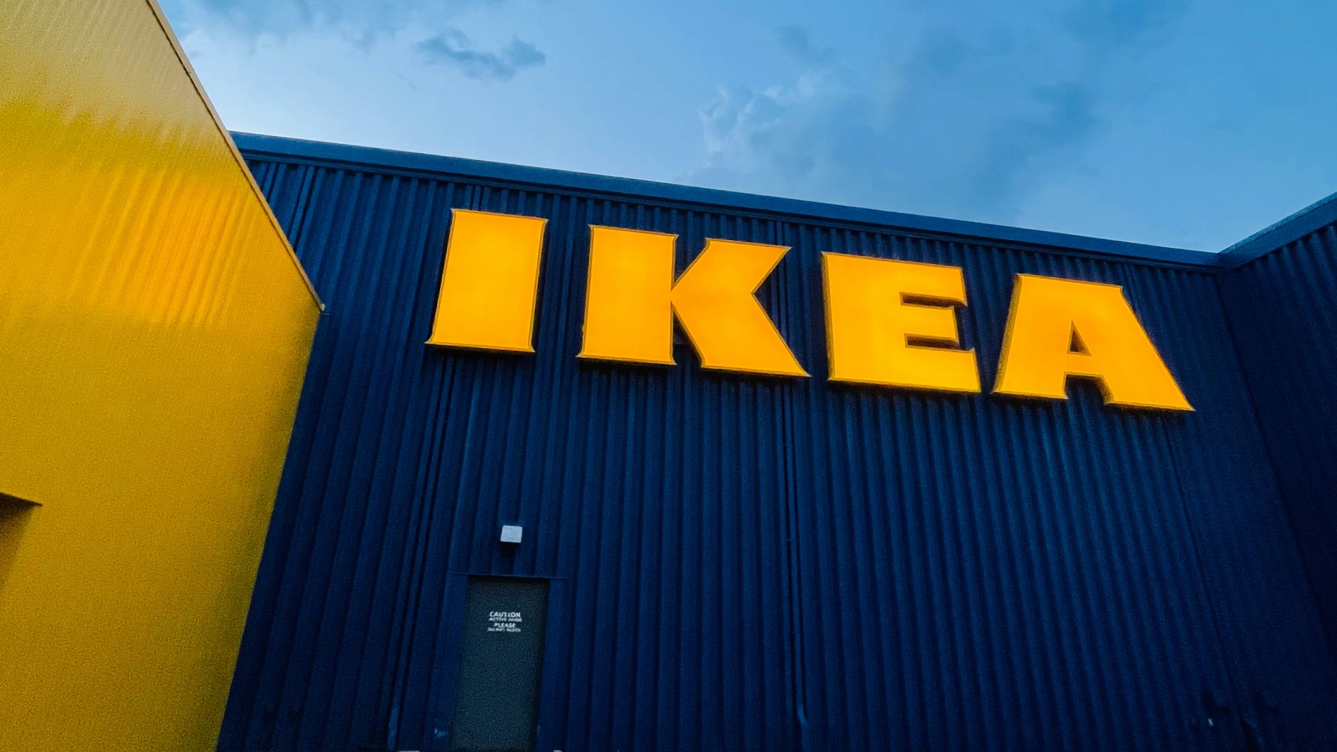 yellow and black building under white clouds during daytime