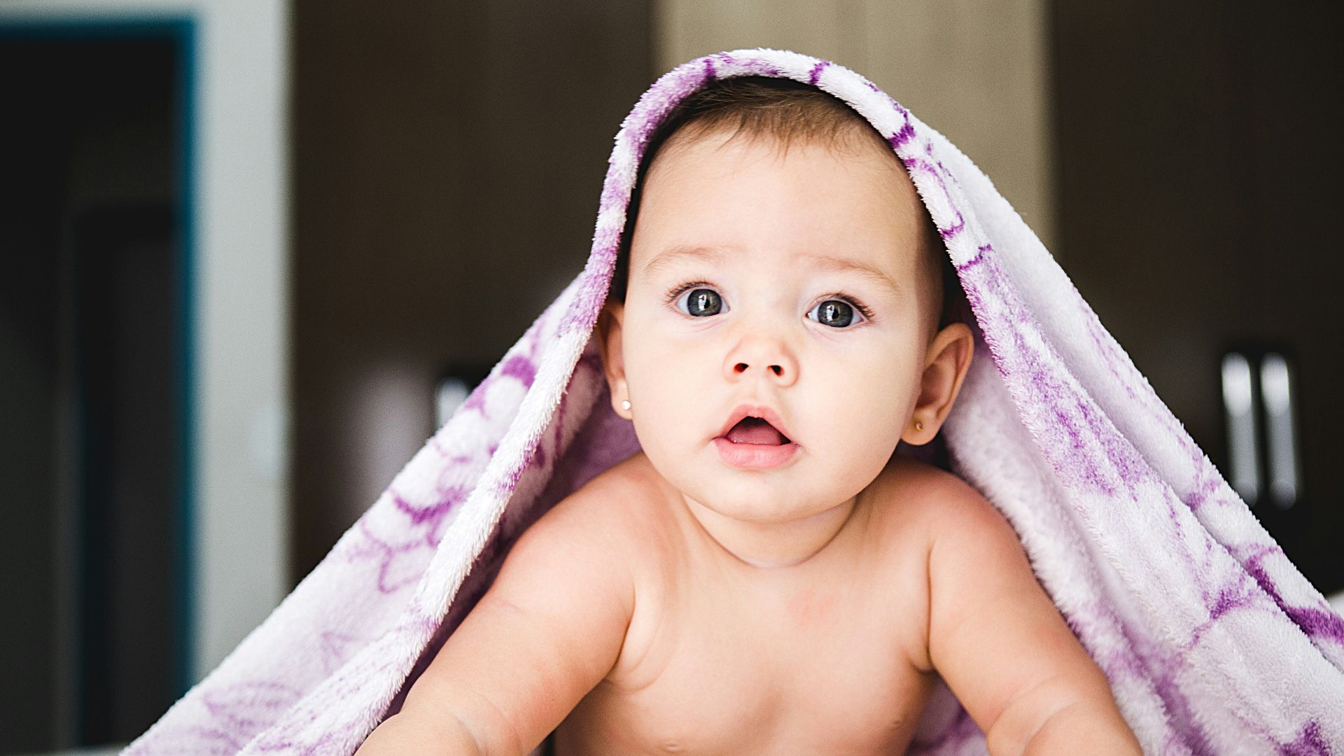 baby under purple blanket