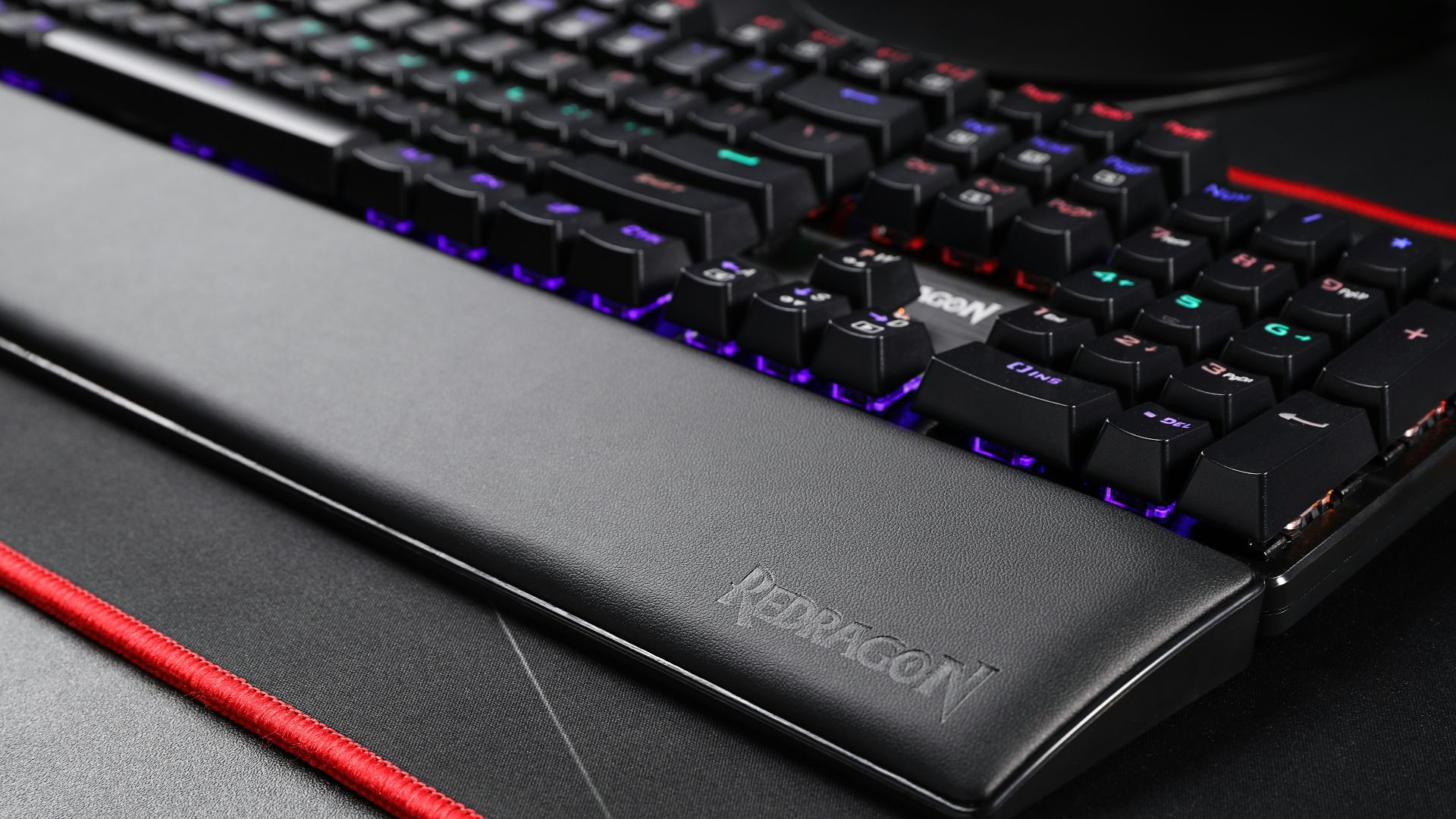 black computer keyboard beside red pencil