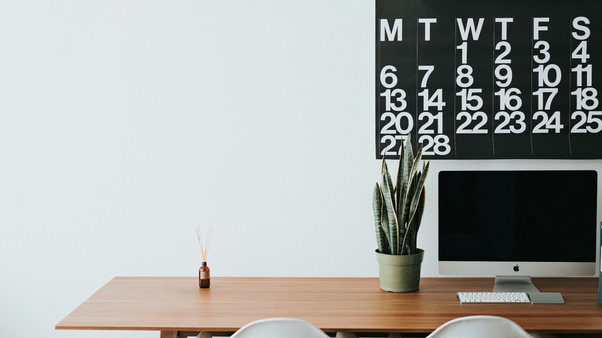 silver iMac on brown wooden desk