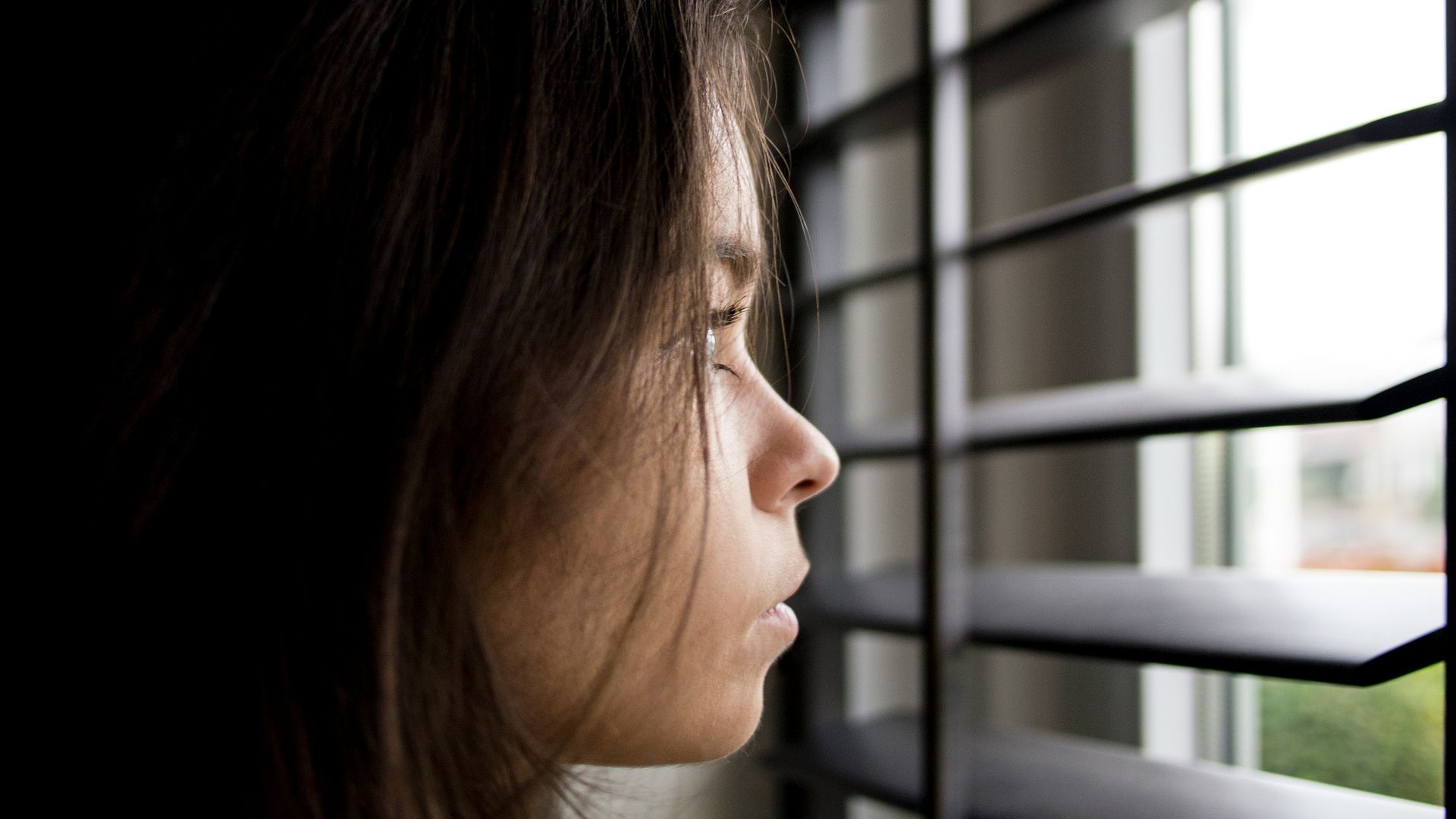 woman facing in front of window