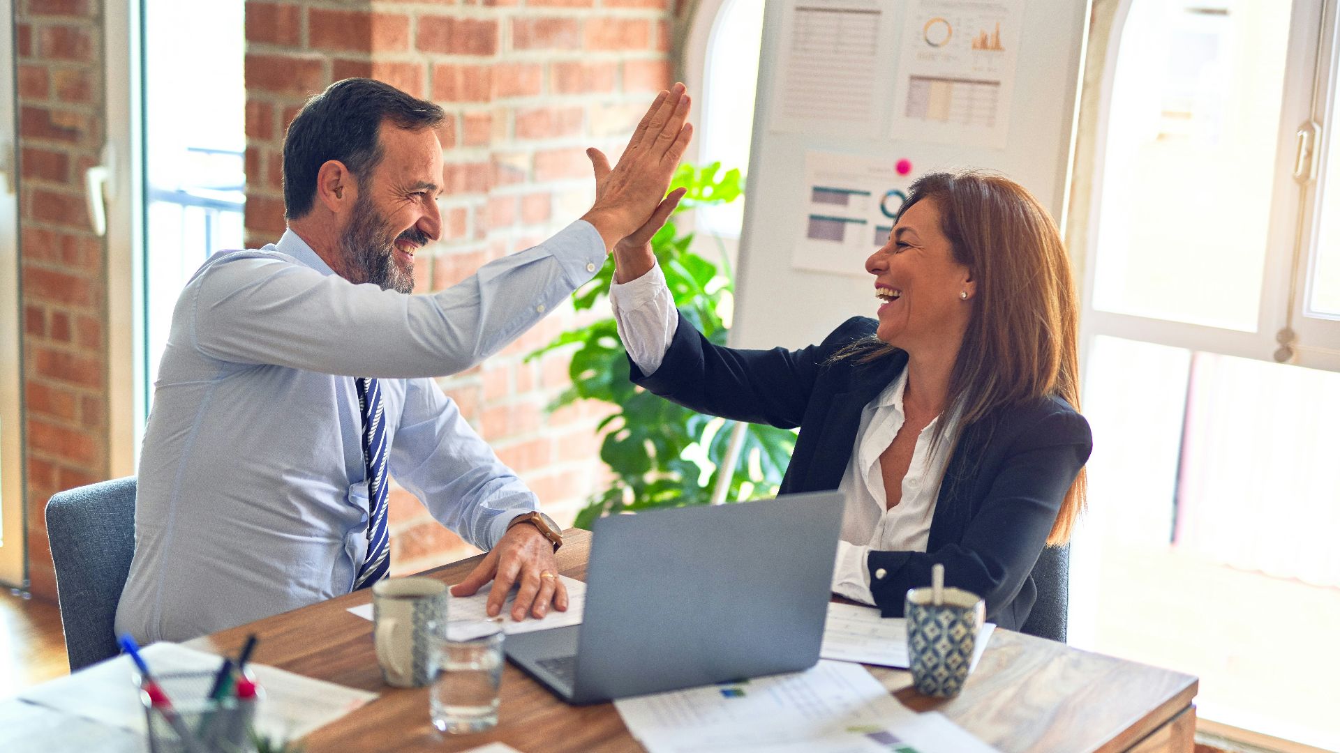 man in white dress shirt sitting beside woman in black long sleeve shirt