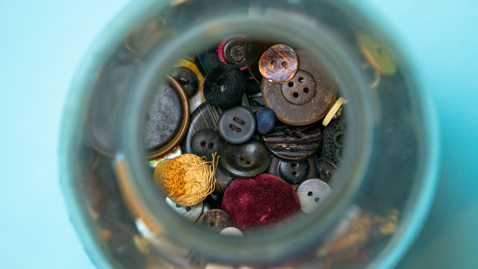 Collection of vintage buttons in a glass jar
