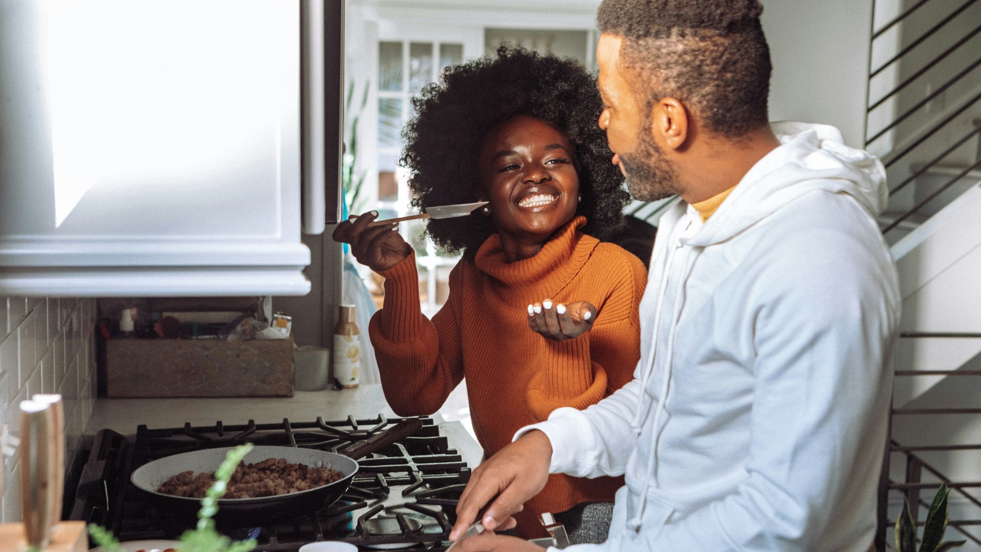 man in white dress shirt holding a woman in brown long sleeve shirt