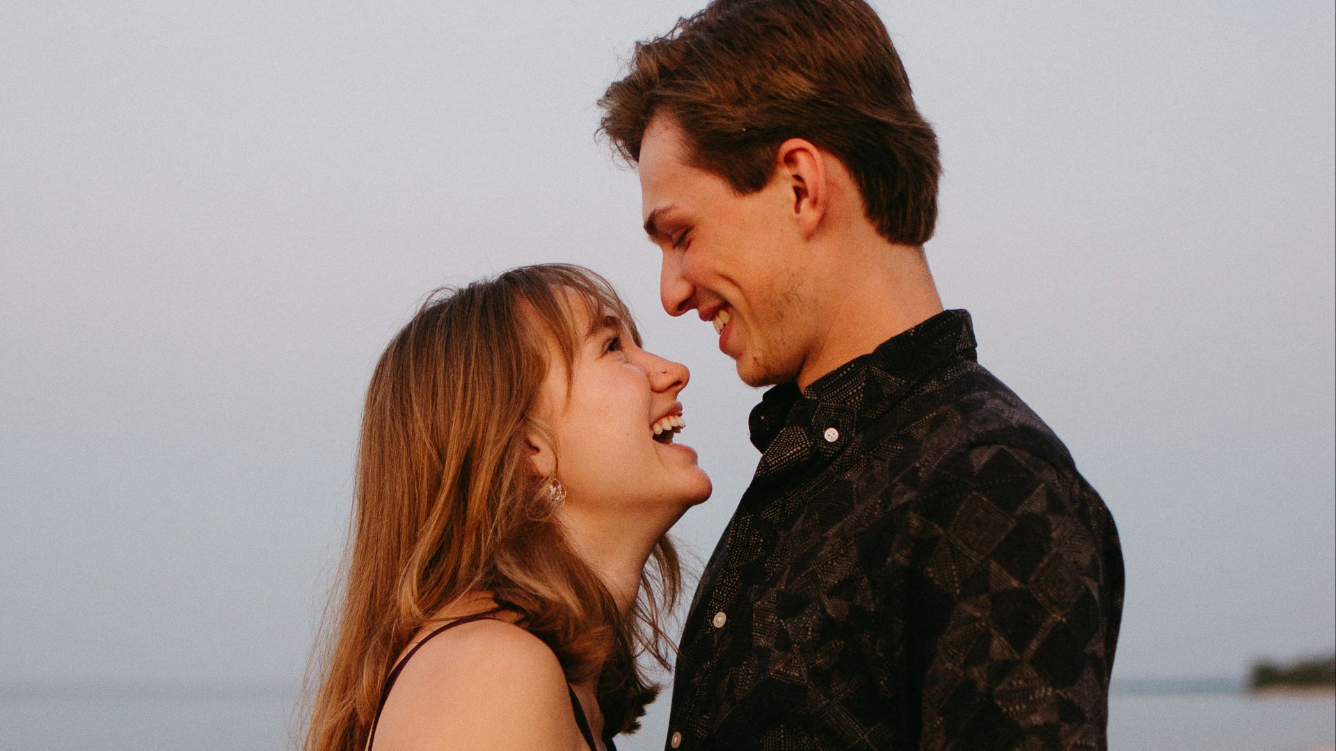 man and woman kissing each other during daytime