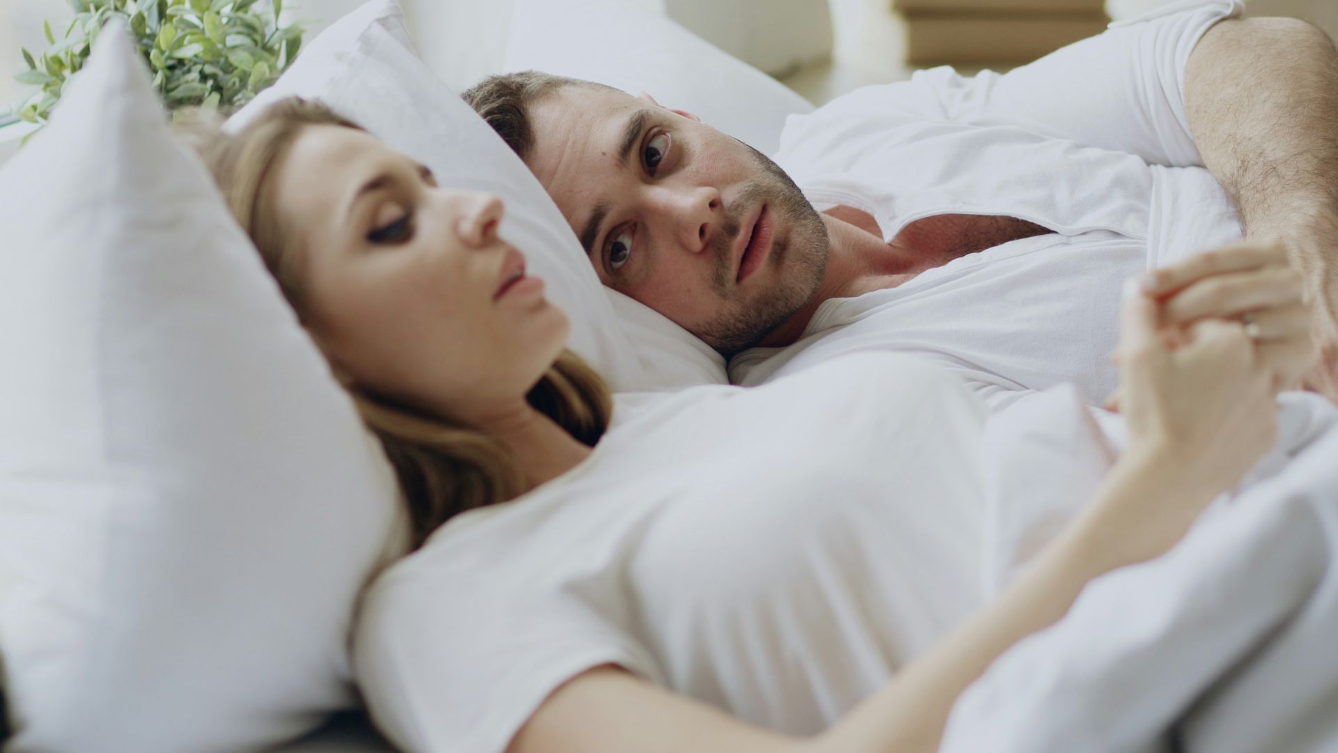 Couple lying in bed together