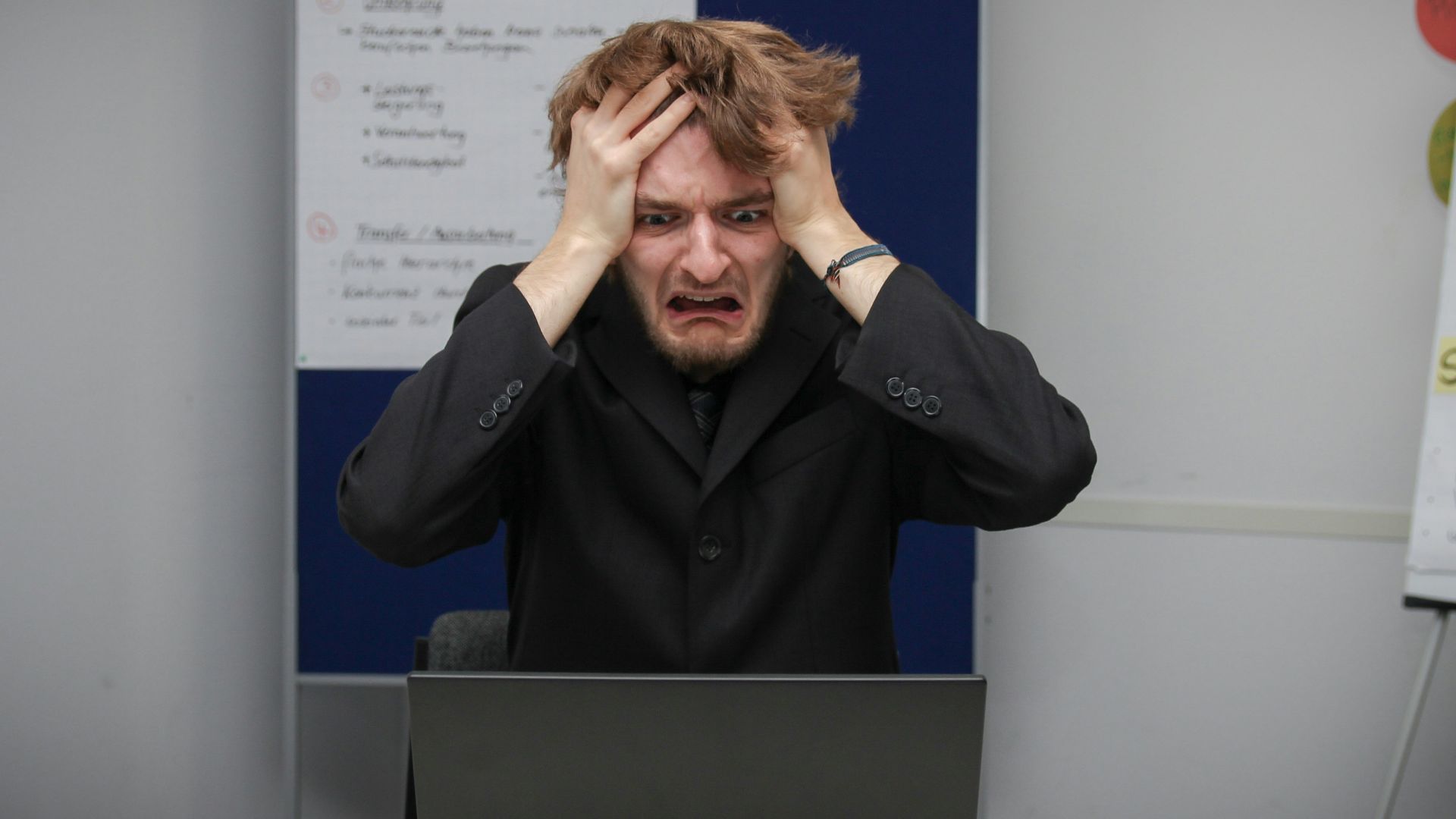 A man sitting in front of a laptop computer
