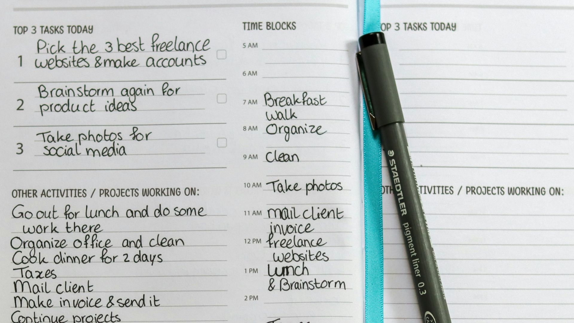 a planner with a pen on top of it