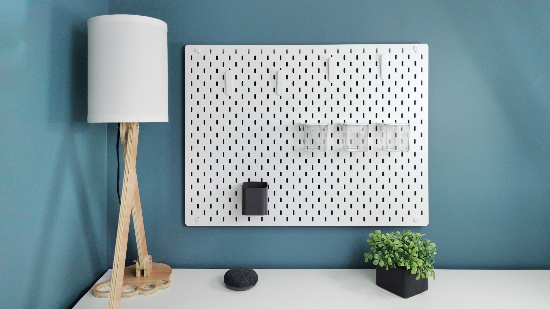 a white desk with a laptop and a lamp