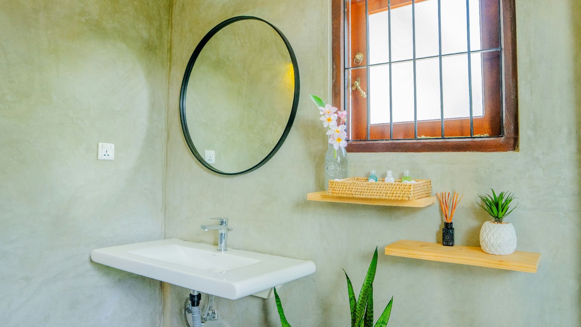 A stylish bathroom with a window and decor.