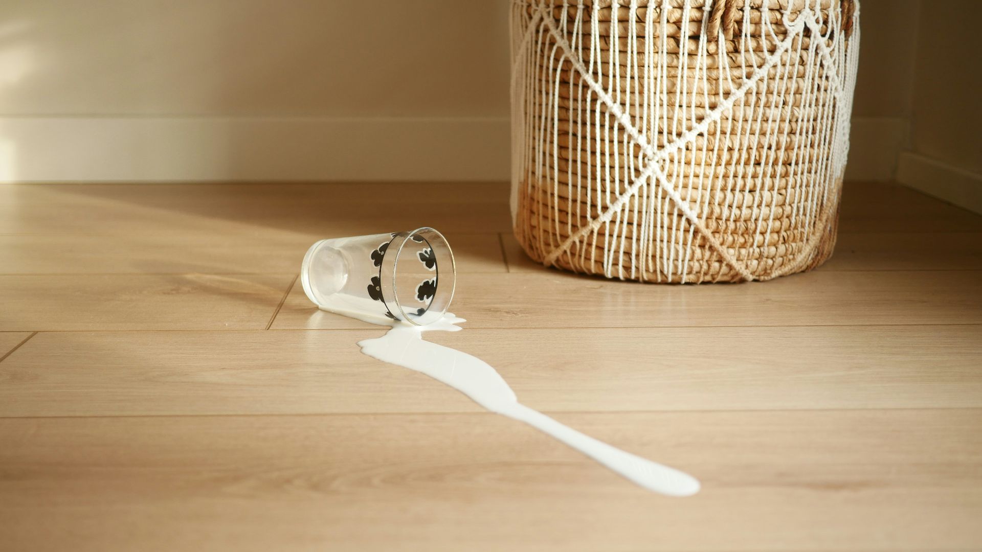 A basket with a toothbrush on a wooden floor