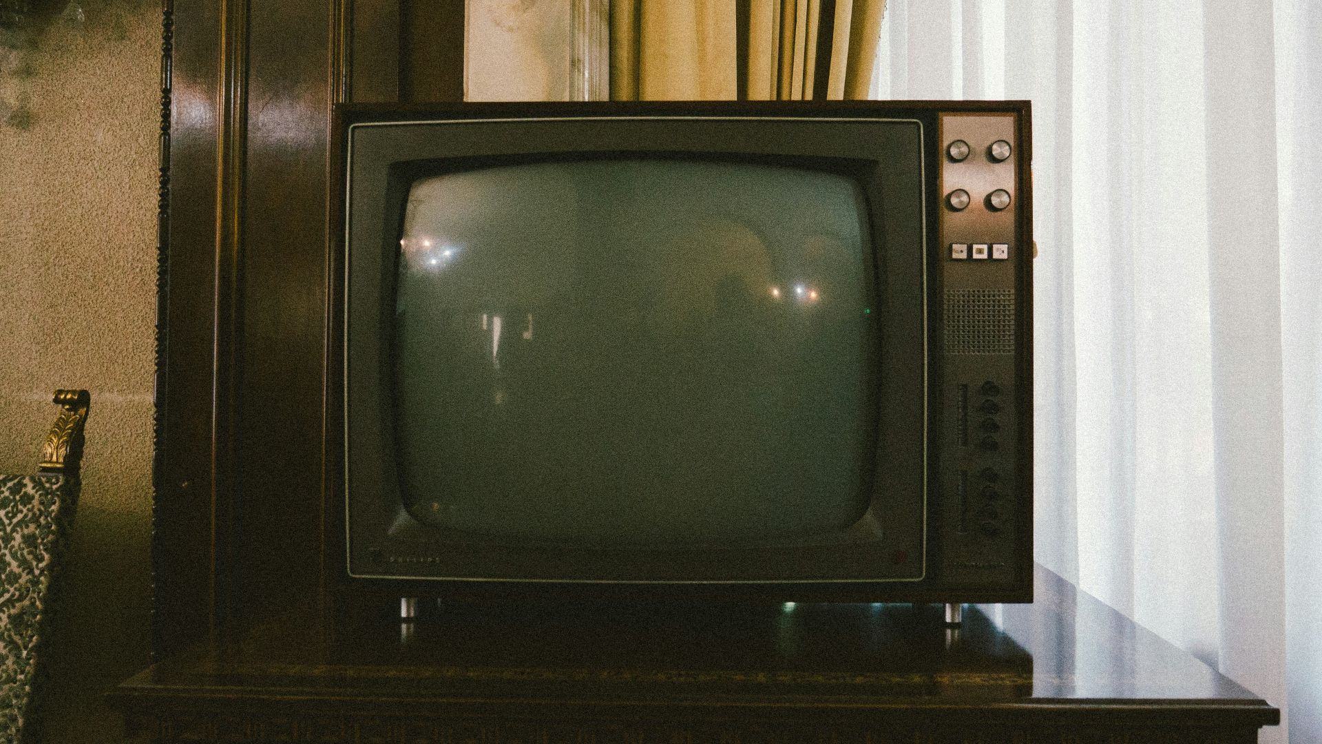 turned-off gray CRT TV on table