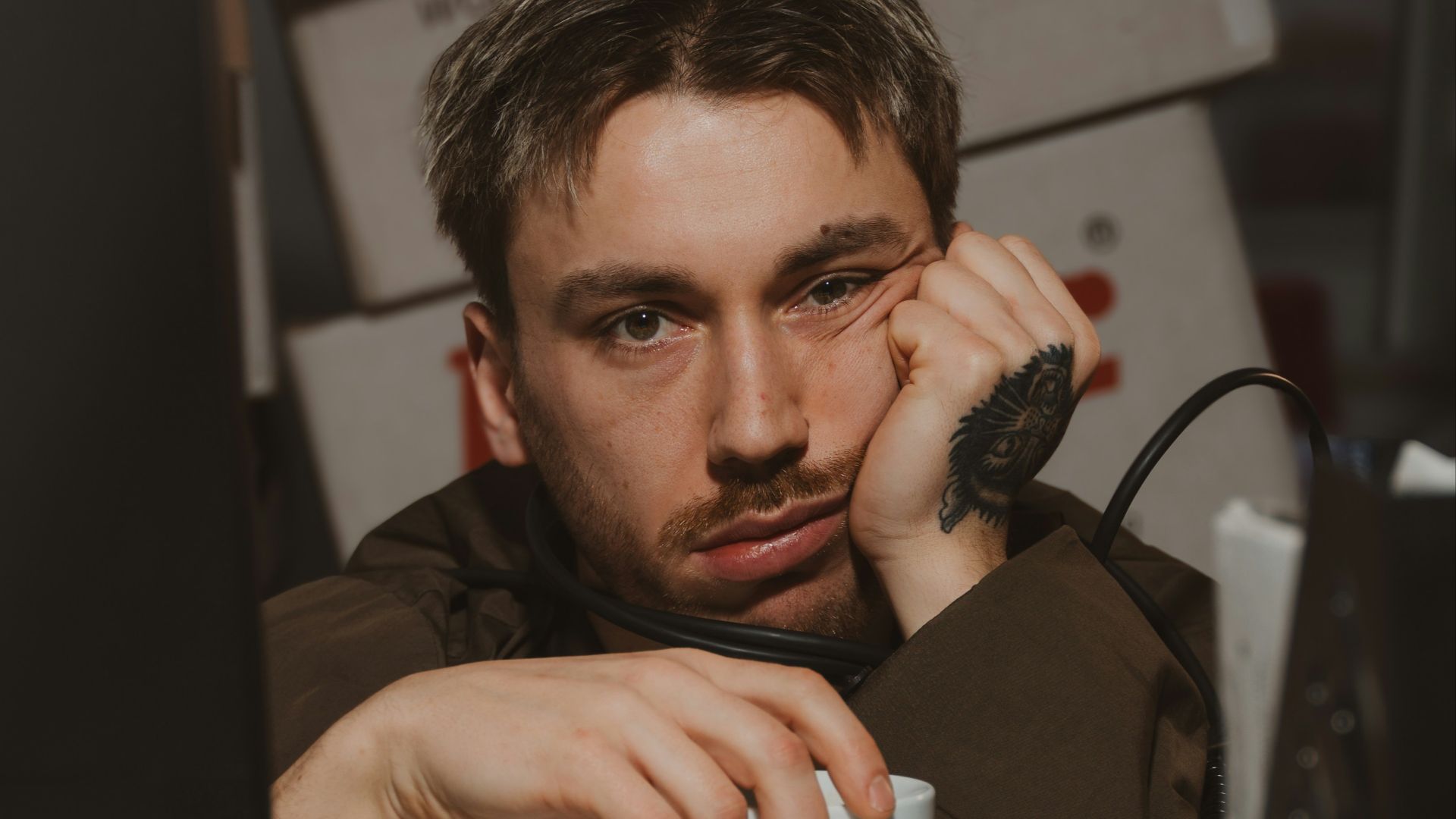 Man is bored and holding a coffee cup.