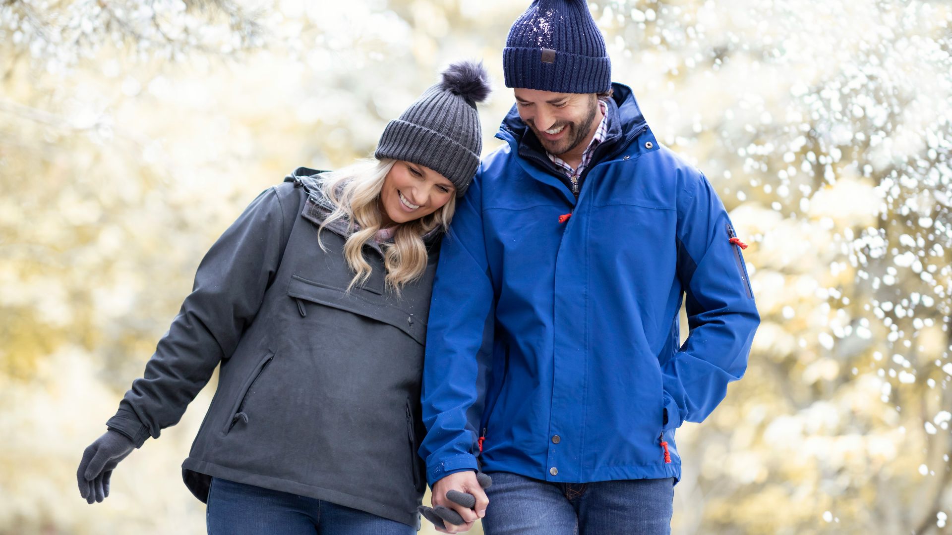 a man and a woman walking through a park