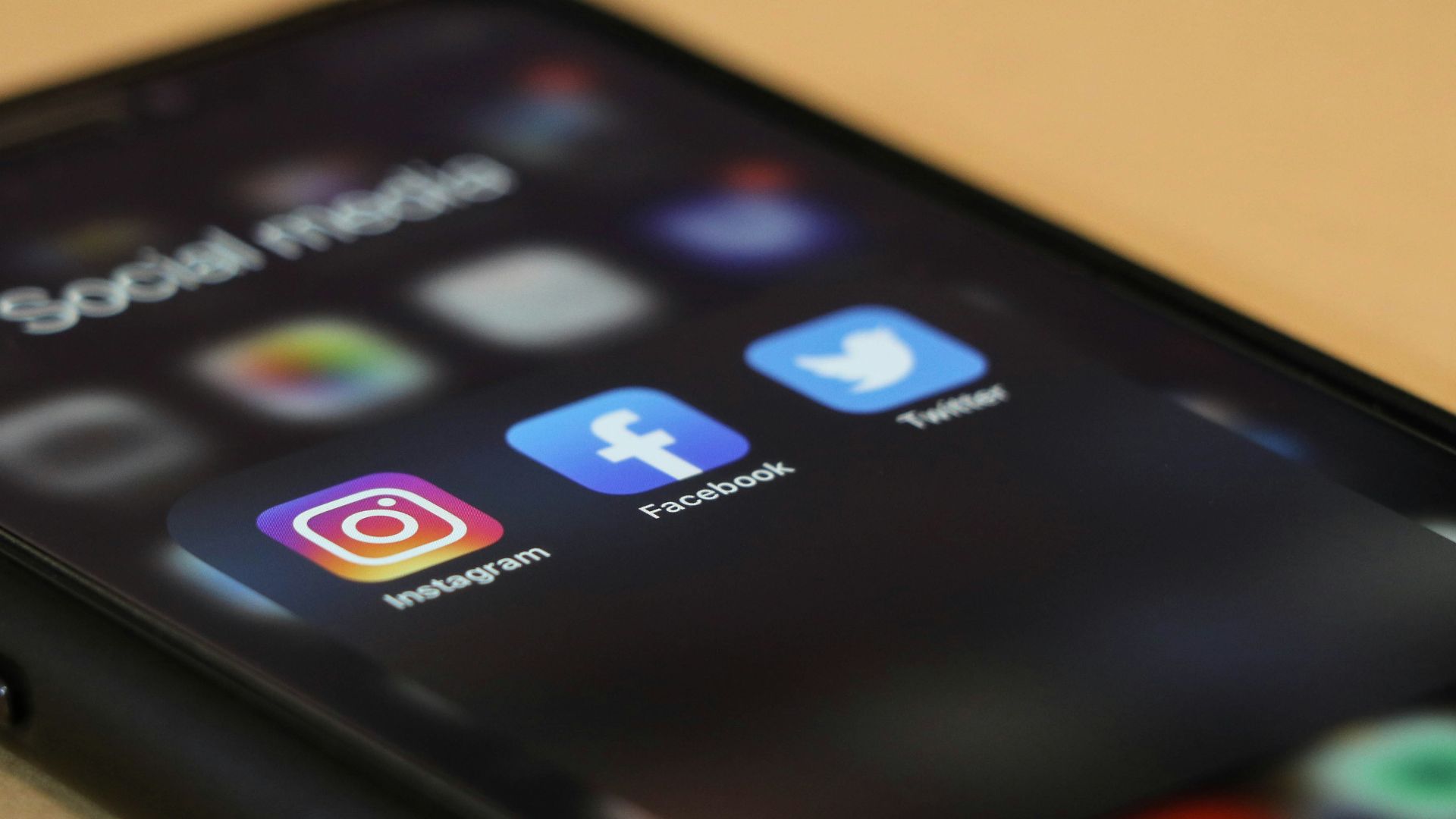 black iphone 4 on brown wooden table