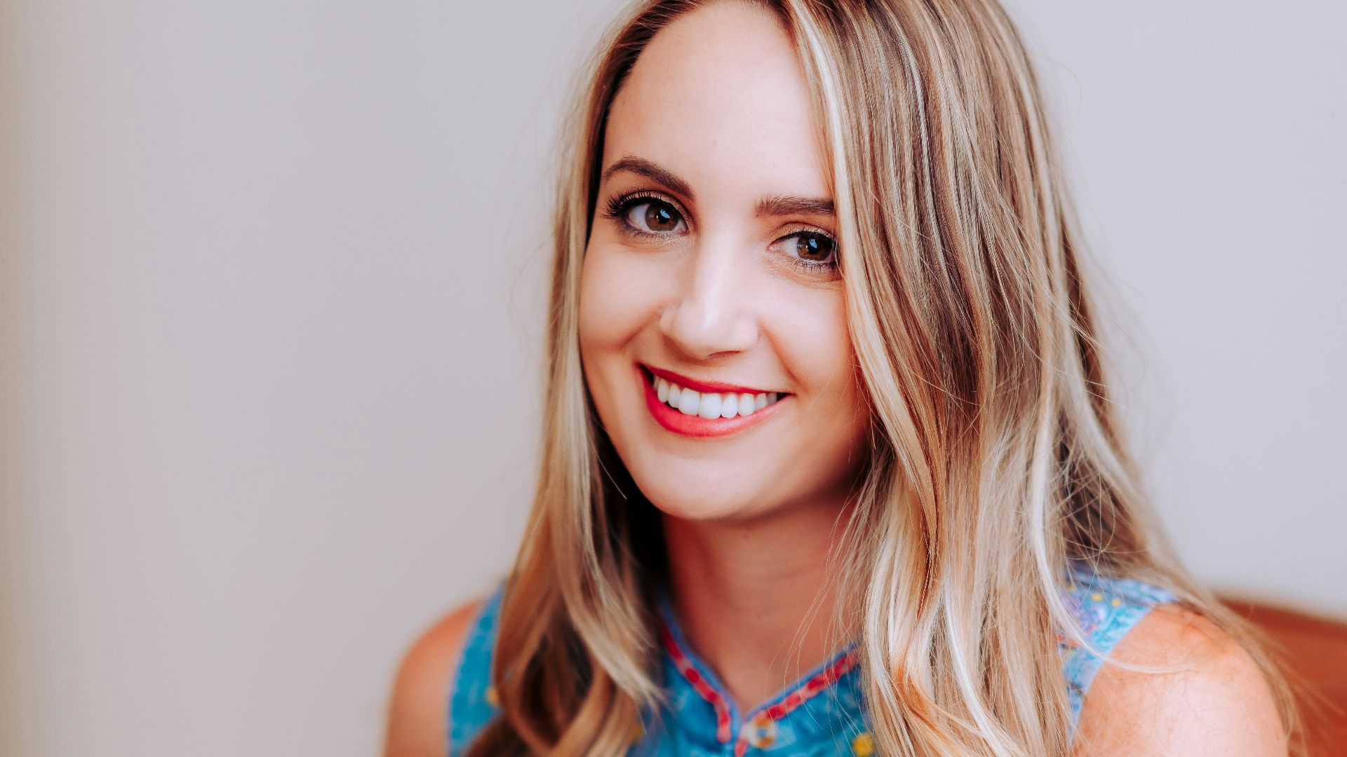 smiling girl in blue sleeveless dress