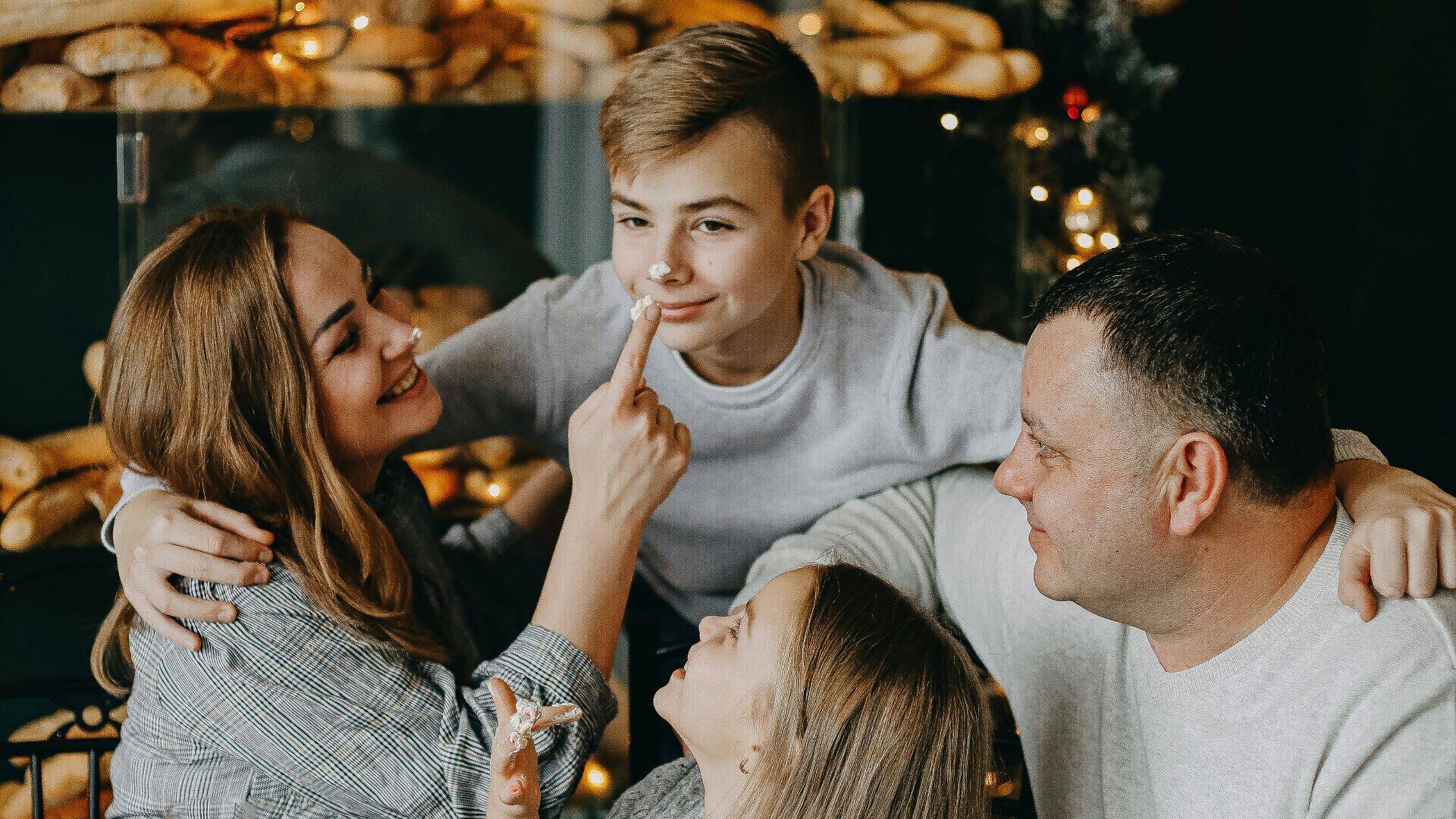 a group of people sitting at a table with food and drinks