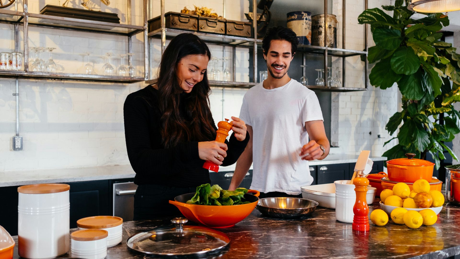 man and woman standing in front of table
