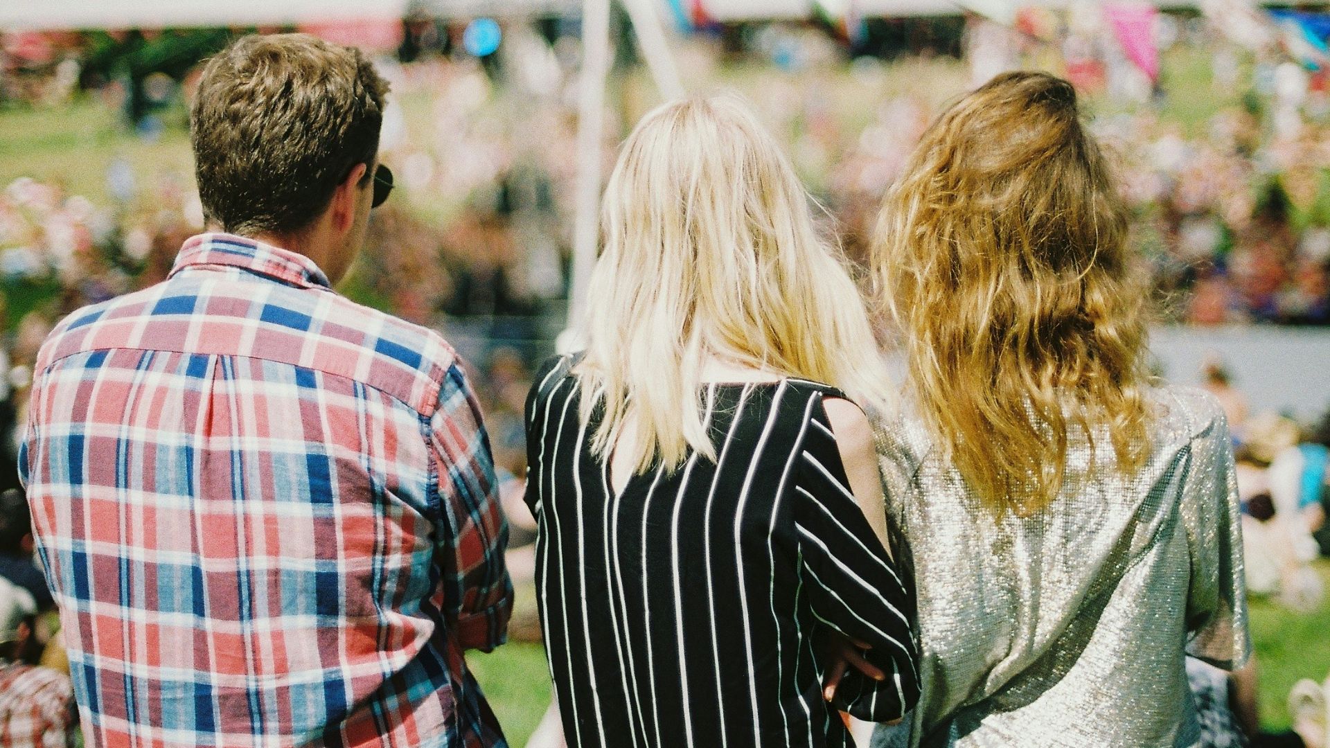 three person's standing front of field