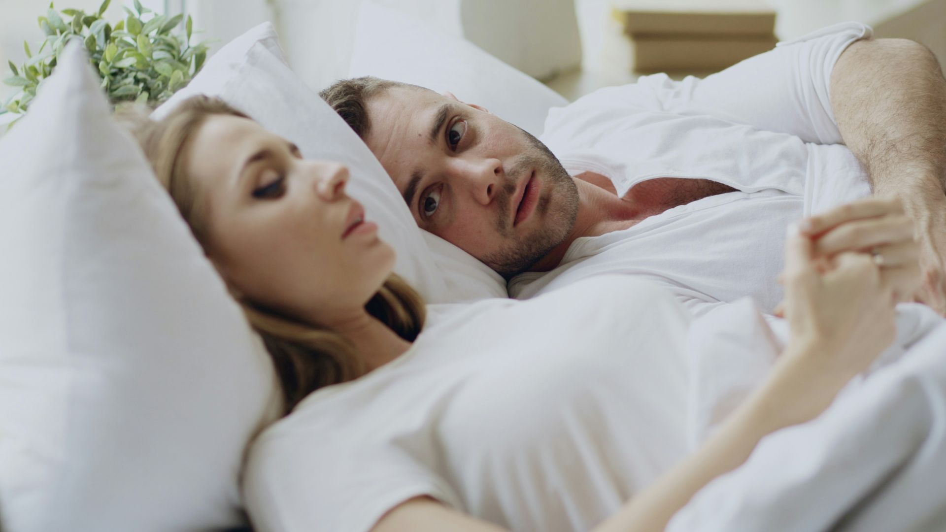 Couple lying in bed together