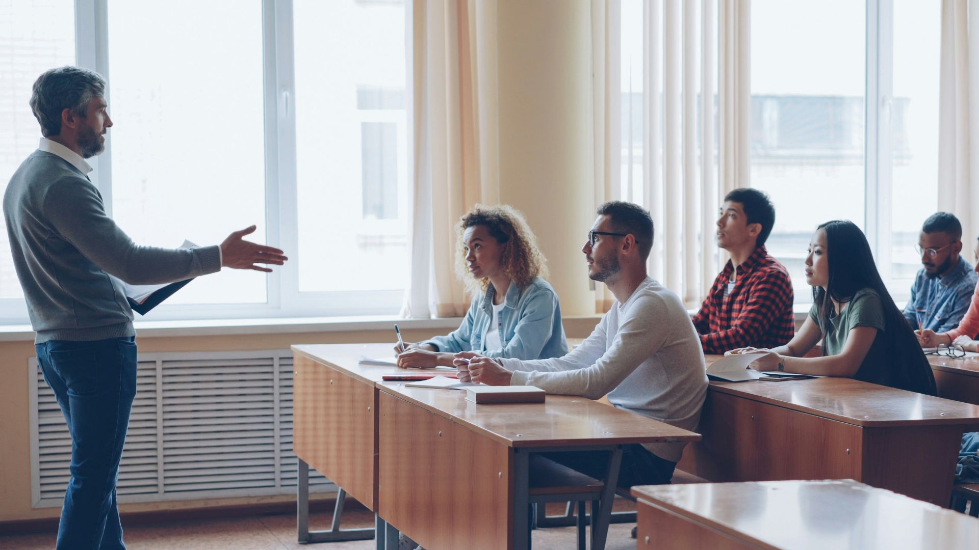 Teacher lecturing students in a classroom setting