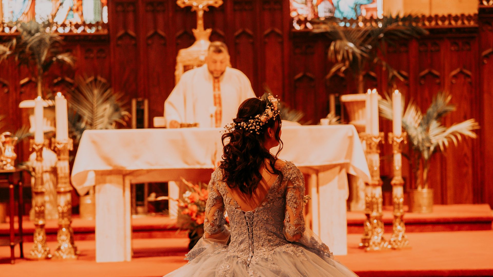 a person in a wedding dress sitting on a chair in a church