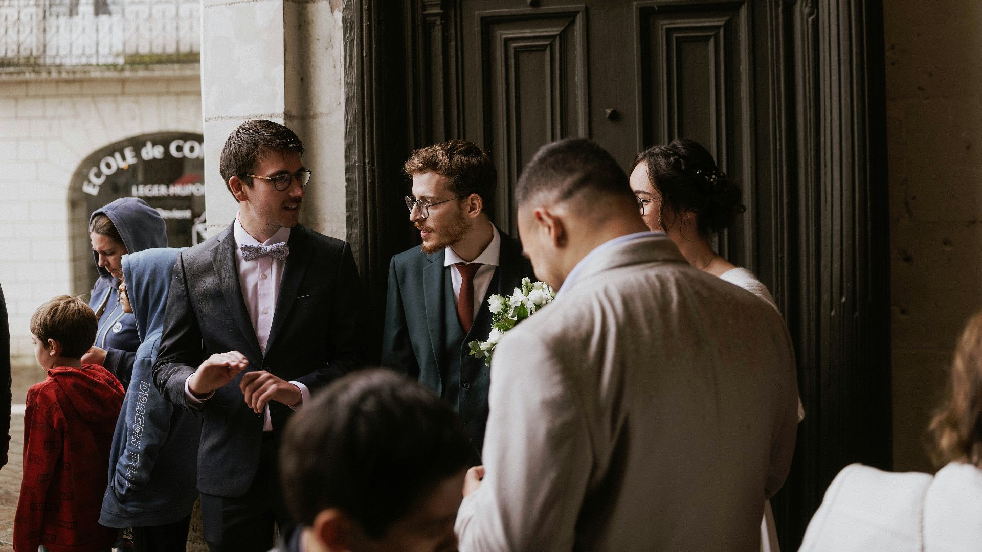 A group of men standing next to each other in front of a building