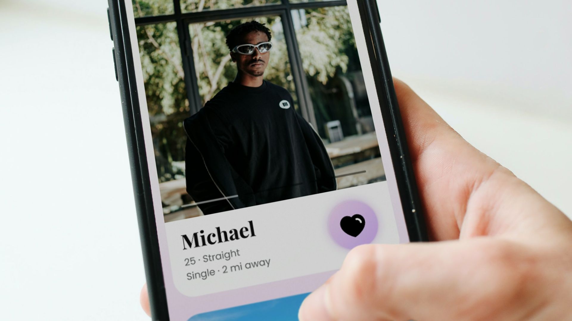 a person holding a cell phone with a picture of a man on it