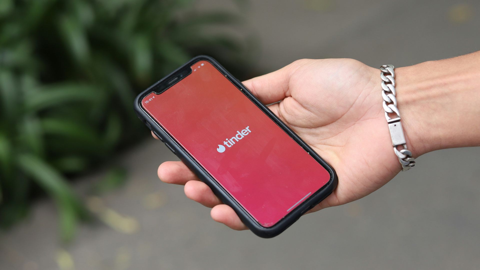 a person holding a red cell phone in their hand